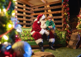 A child sits on Santa's lap at Camp Christmas
