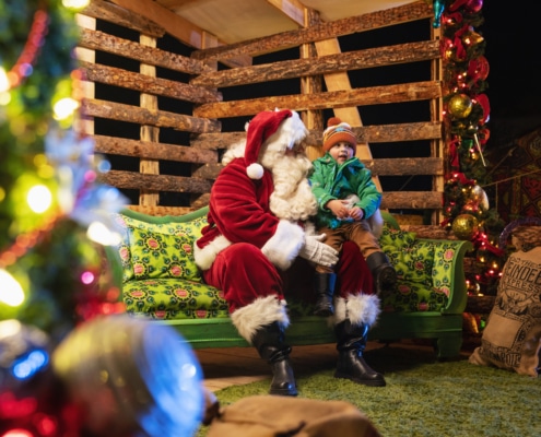 A child sits on Santa's lap at Camp Christmas