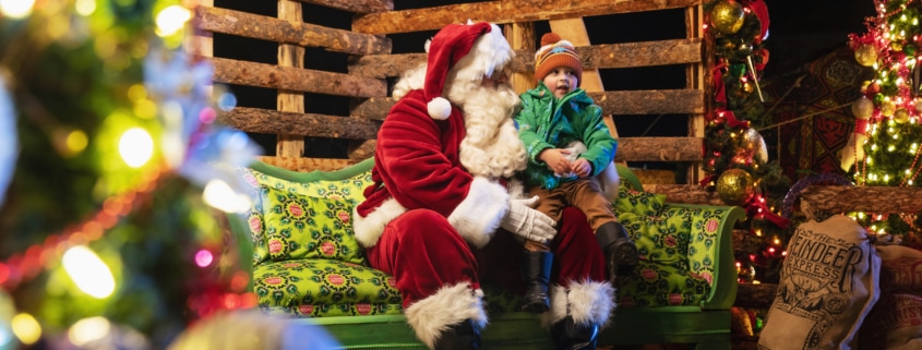 A child sits on Santa's lap at Camp Christmas