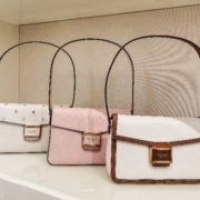 Purses lined up on a shelf in Kate Spade