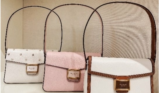 Purses lined up on a shelf in Kate Spade