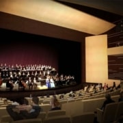 People seated in the Lone Tree Arts Center theatre while a choir performs