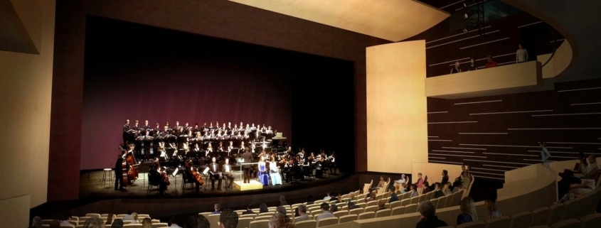 People seated in the Lone Tree Arts Center theatre while a choir performs