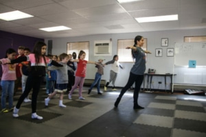 A teacher leads a dance class with young children at Cleo Parker Robinson Dance