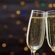 Champagne glasses toasting against a glittering background