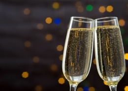 Champagne glasses toasting against a glittering background