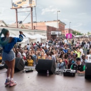 A woman performs in front of a large crowd at Juneteenth Music Festival