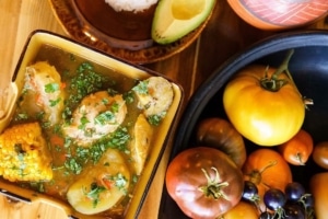 Colombian food plated next to ripe tomatoes in La Chiva