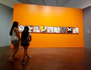 People observe a gallery inside the Denver Art Museum