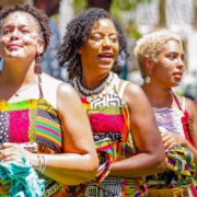 Women wearing traditional African garments stand together during the Colorado Black Arts Festival