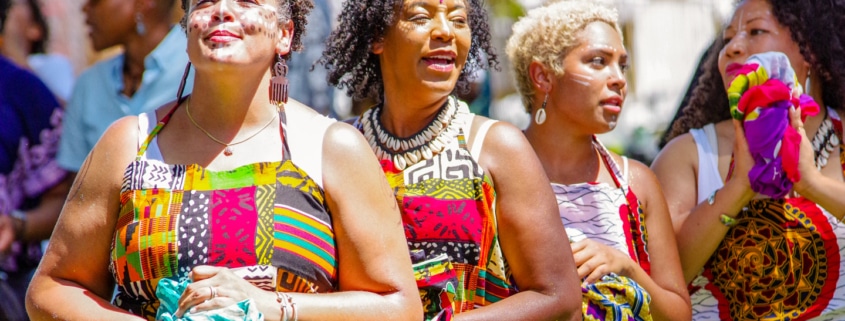 Women wearing traditional African garments stand together during the Colorado Black Arts Festival