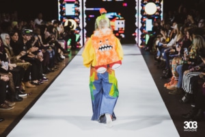 A model walks the runway in Meow Wolf style clothing