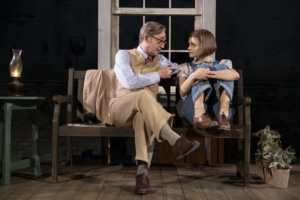 Atticus and Scout sit together on a bench in To Kill a Mockingbird