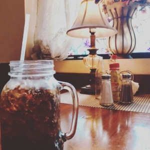 A cup of coffee on a dining table at Cora's Cafe