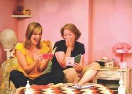 Linda Klein and Barbara Gehring sit on a bed reading their diaries in The Secret Comedy of Women