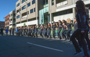 Irish step dancers perform in a line outside in downtown Denver