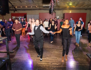 Instructors lead a Latin dance class in La Rumba