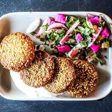 A plate of sesame crusted patties with a side salad at Yahya's Mediterranean Grill