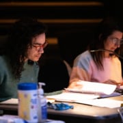 Playwright Jake Brasch and director Shelley Butler are seated at a table during rehearsal for the reservoir