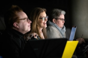 Sandy Rustin smiles as she watches The Suffragette's Murder in rehearsal