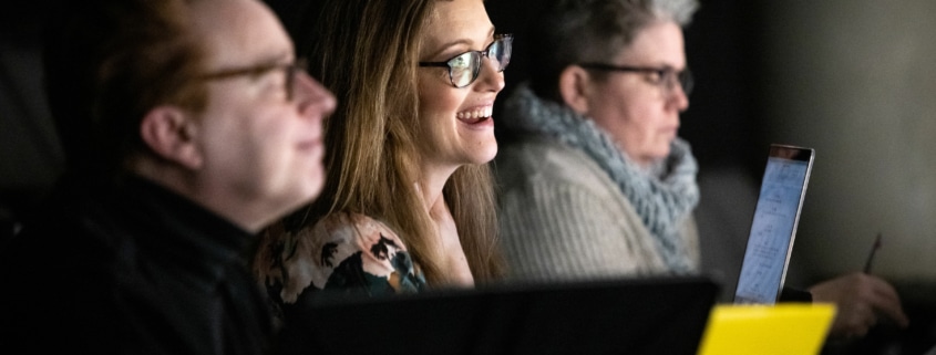 Sandy Rustin smiles as she watches The Suffragette's Murder in rehearsal