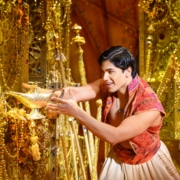 Aladdin reaches for the magic lamp in the underground treasure trove, the Cave of Wonders