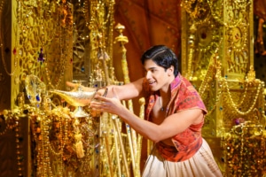 Aladdin reaches for the magic lamp in the underground treasure trove, the Cave of Wonders