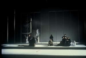 The cast of The Cherry Orchard sits around a desolate stage