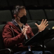 Director Jerry Ruiz gestures while reading notes for Cebollas