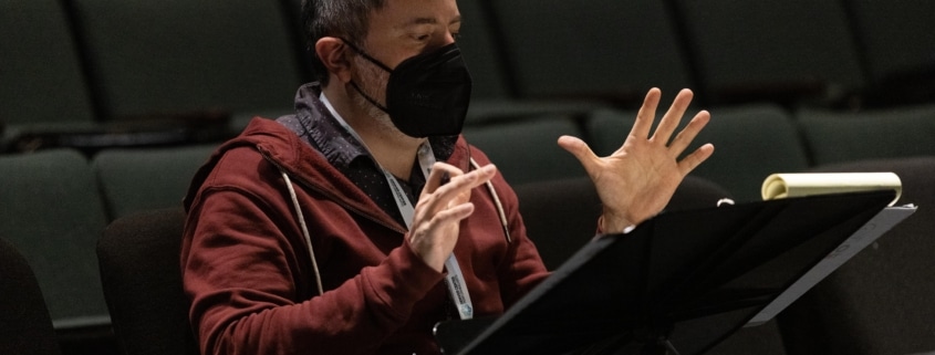 Director Jerry Ruiz gestures while reading notes for Cebollas