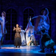 Anya stands center stage with her music box. Dancers are lifted in the air around her as Anya remembers the palace ballroom.