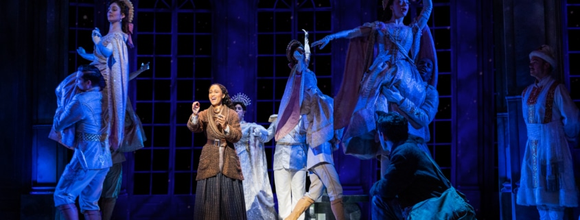 Anya stands center stage with her music box. Dancers are lifted in the air around her as Anya remembers the palace ballroom.