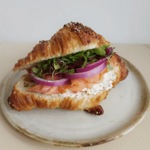 A smoked salmon sandwich on a croissant