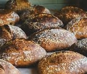 A close up of rows of crusty loaves of bread at Raleigh Street Bakery