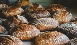 A close up of rows of crusty loaves of bread at Raleigh Street Bakery