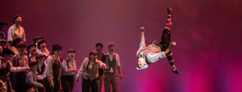 A student performs a backflip while performing in Central High School's production of Newsies during the Bobby G Awards