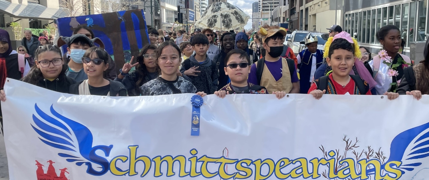 A group of students dressed in costume march in the DPS Shakespeare Festival parade