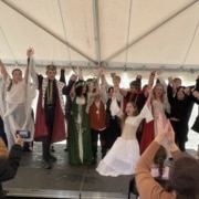 A large number of students clasp hands as they take a bow after performing in the DPS Shakespeare Festival