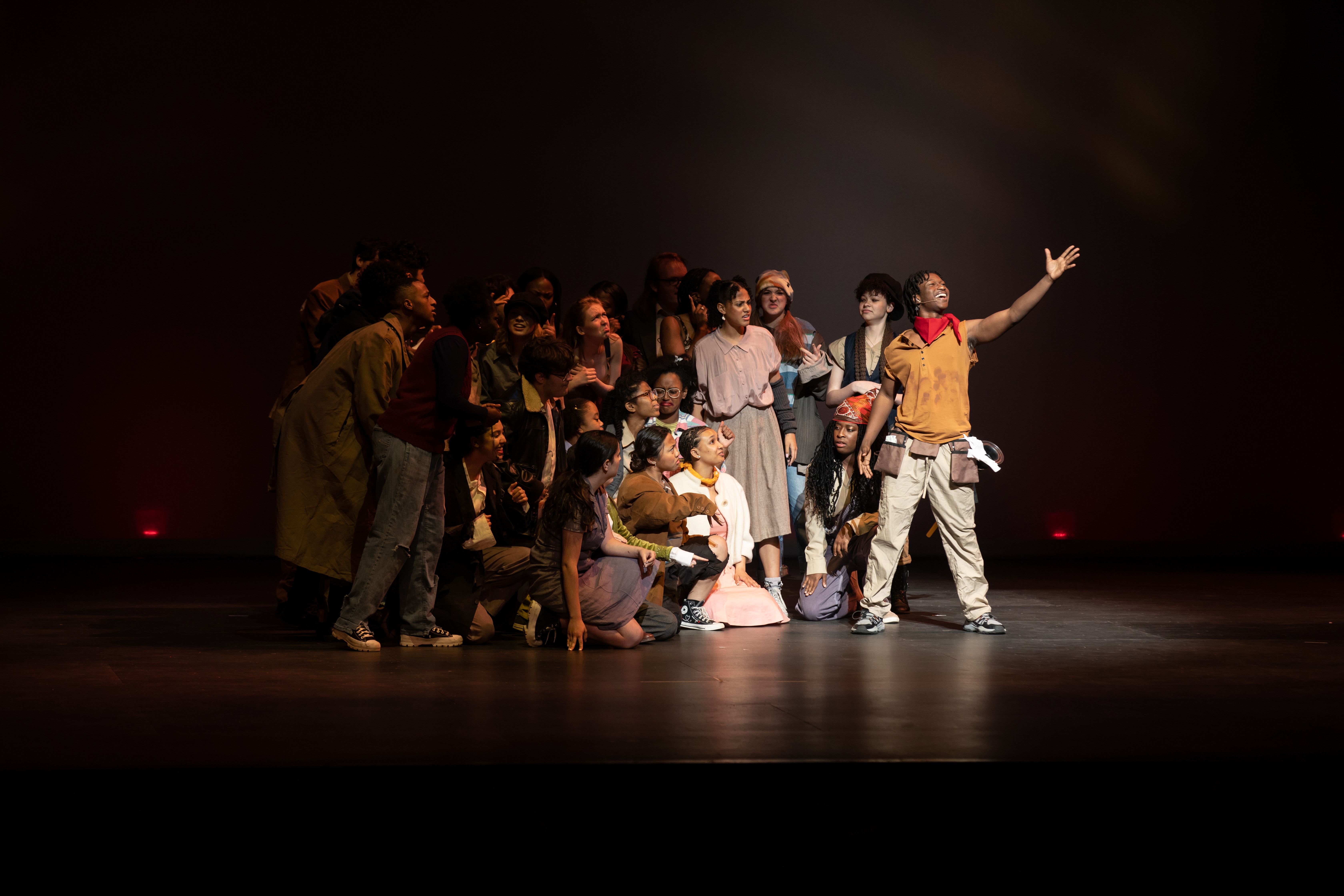 The cast of Overland High School's production of Urinetown huddle behind their Bobby Strong as he sings a note during their performance at the Bobby G Awards