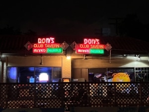 Exterior of Don's Club Tavern, lit up at night