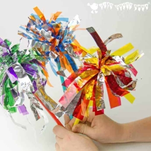 Three cellophane and foil sparklers held up by a child's hands