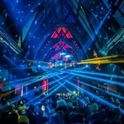 A neon light show in the Church Nightclub. The dance floor is packed