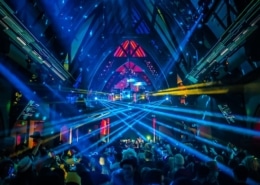 A neon light show in the Church Nightclub. The dance floor is packed