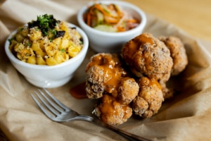 A plate of fried cauliflower, vegan macaroni, and slaw from Watercourse Foods