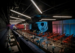 The main listening room at Dazzle's new location. Many red chairs circle a small stage for a jazz band.