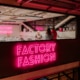 Factory Fashion glows in neon pink lettering outside the workshop in Stanley Marketplace.