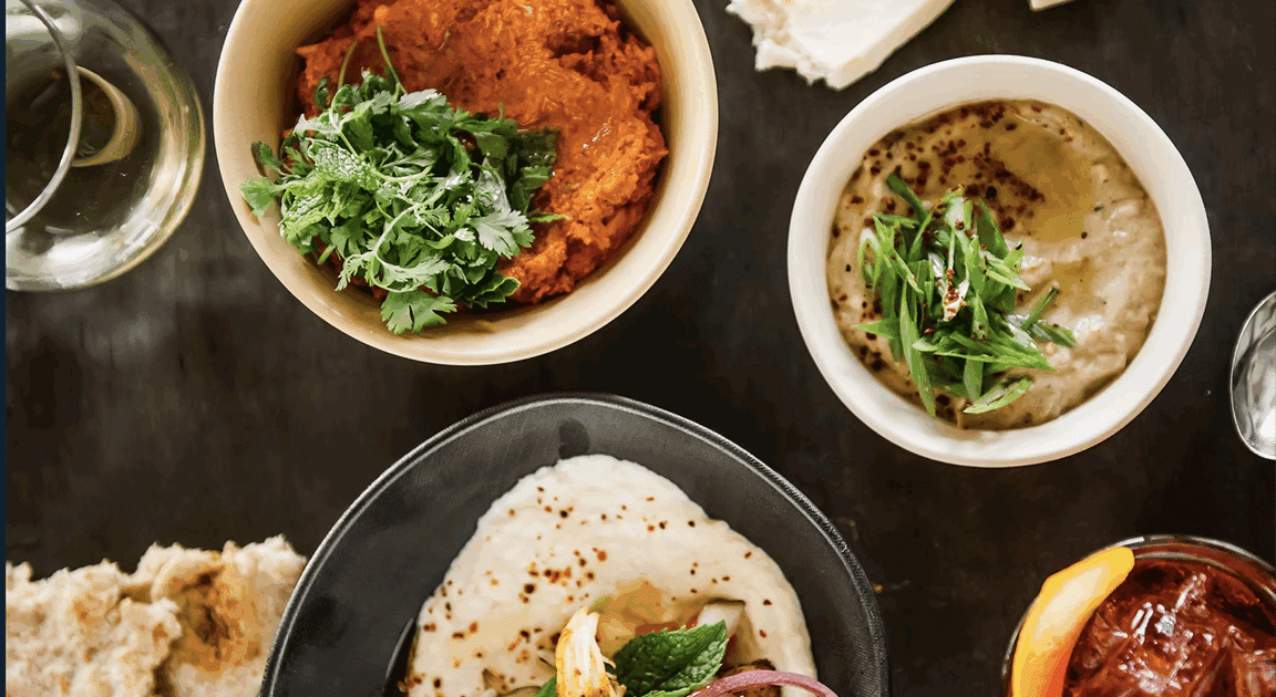 An assortment of Mediterranean dips and spreads including hummus