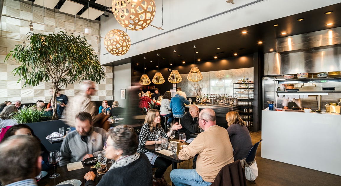 The interior of Annette at Stanley Marketplace. Patrons are seated at tables, eating.