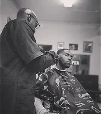 A barber cuts a man's hair