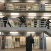 Prisoners perform along a stairway in the prison